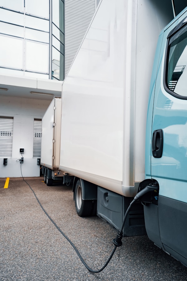 Long truck charging at a loading dock with an extra long charging cable.